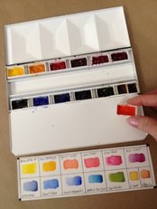 Watercolor paints in pans in a travel palette.