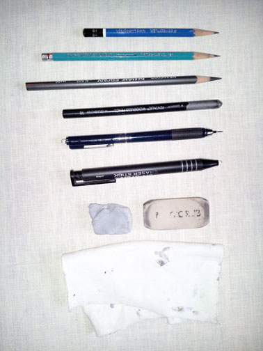 Various pencils that might be used by an urban sketcher, erasers, and rag